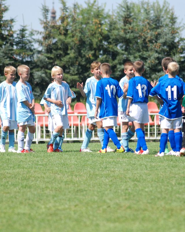 Two youth soccer teams greeting each other after a match
