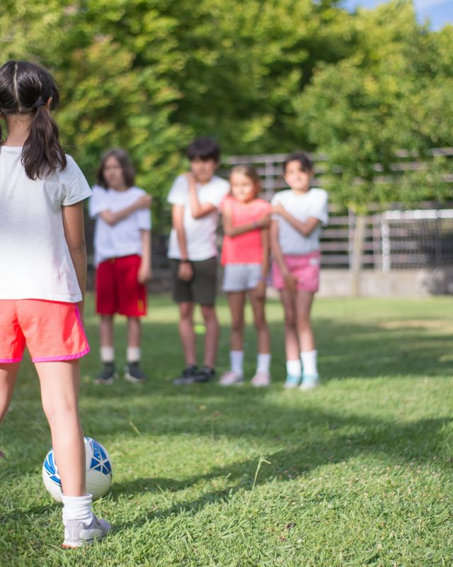 A young player with her team on the field