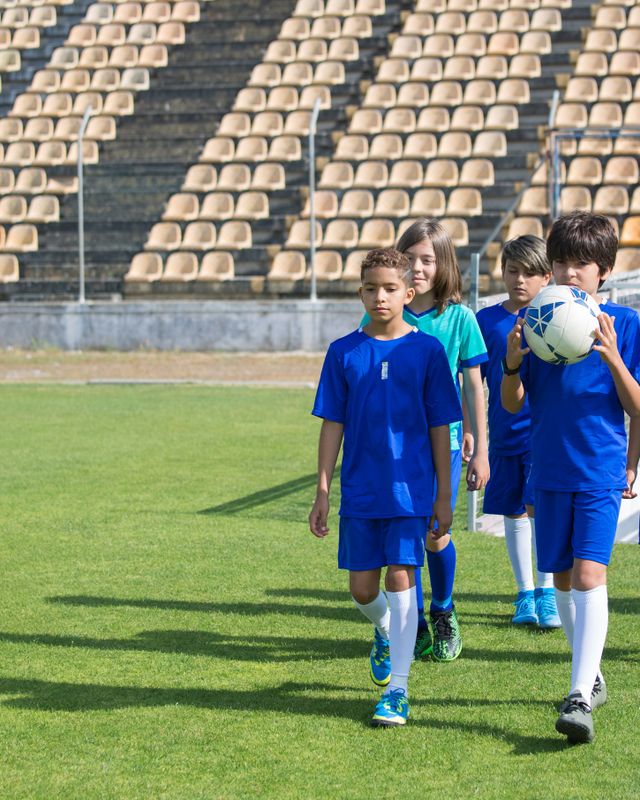 A youth soccer team resting together during practice