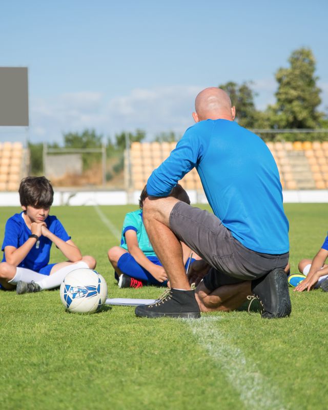 A coach helping a young player during practice