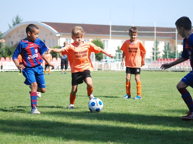A young player dribbling a soccer ball during training